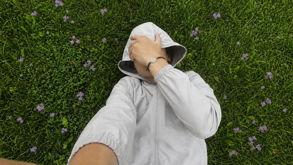 Untracked bracelet on a wrist, lying in the grass among wildflowers
