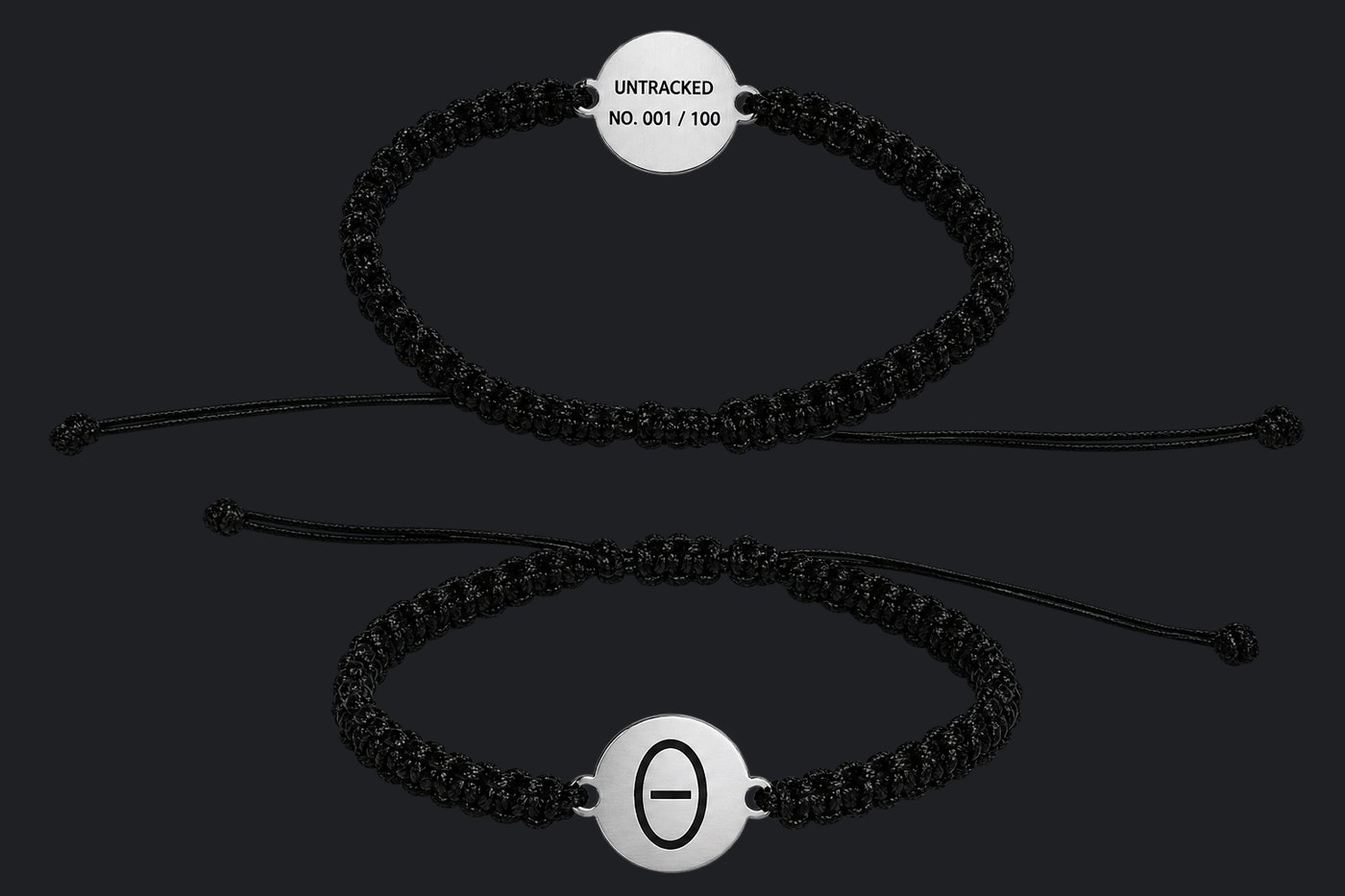 Untracked Drop 01 bracelet — matte black cord with a brushed steel disc, engraved with the mark on the front and UNTRACKED No. 001/100 on the back